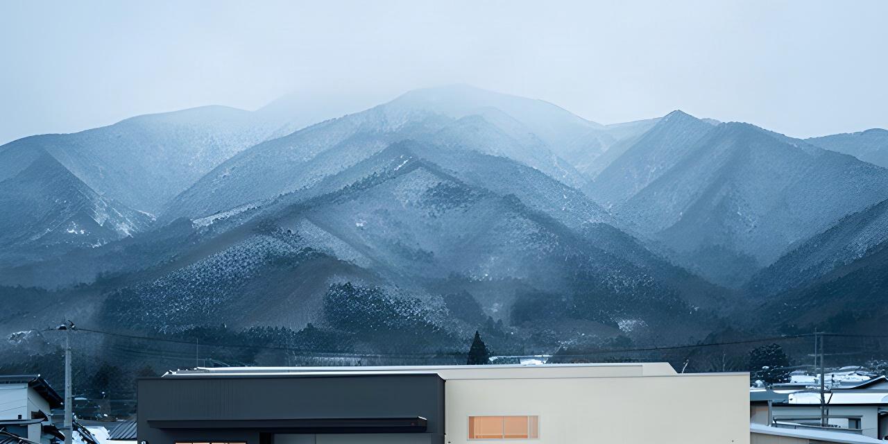 山形県長井市の壁紙製造拠点と雪の残る山並み